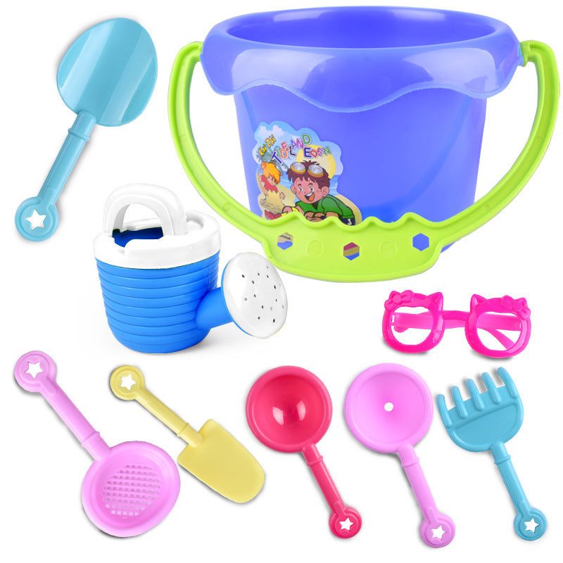 Children Playing In The Sand With Beach Toys
