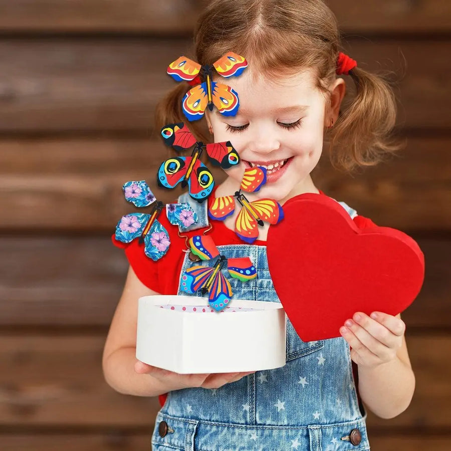 Schmetterling spielzeug fuer Kinder, Maedchen haelt Geschenkbox mit fliegenden Schmetterlingen